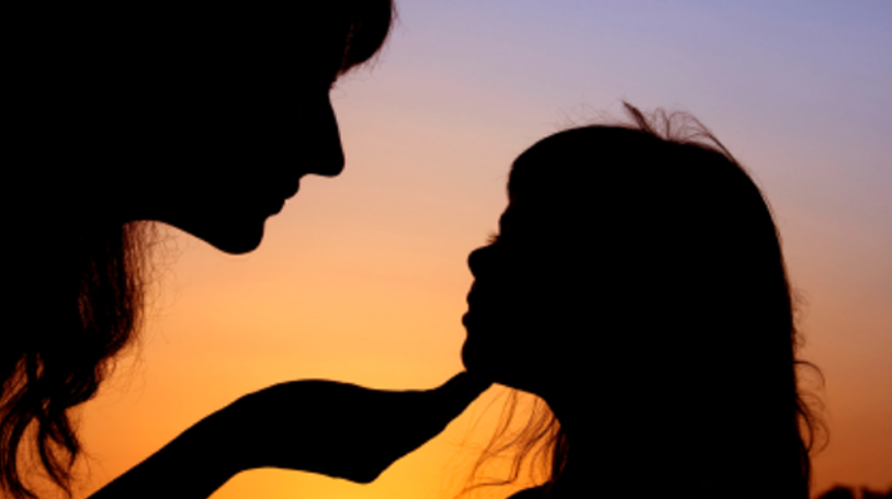 Mujer acariciando a su niña interior en una escena simbólica de conexión, cuidado y sanación emocional